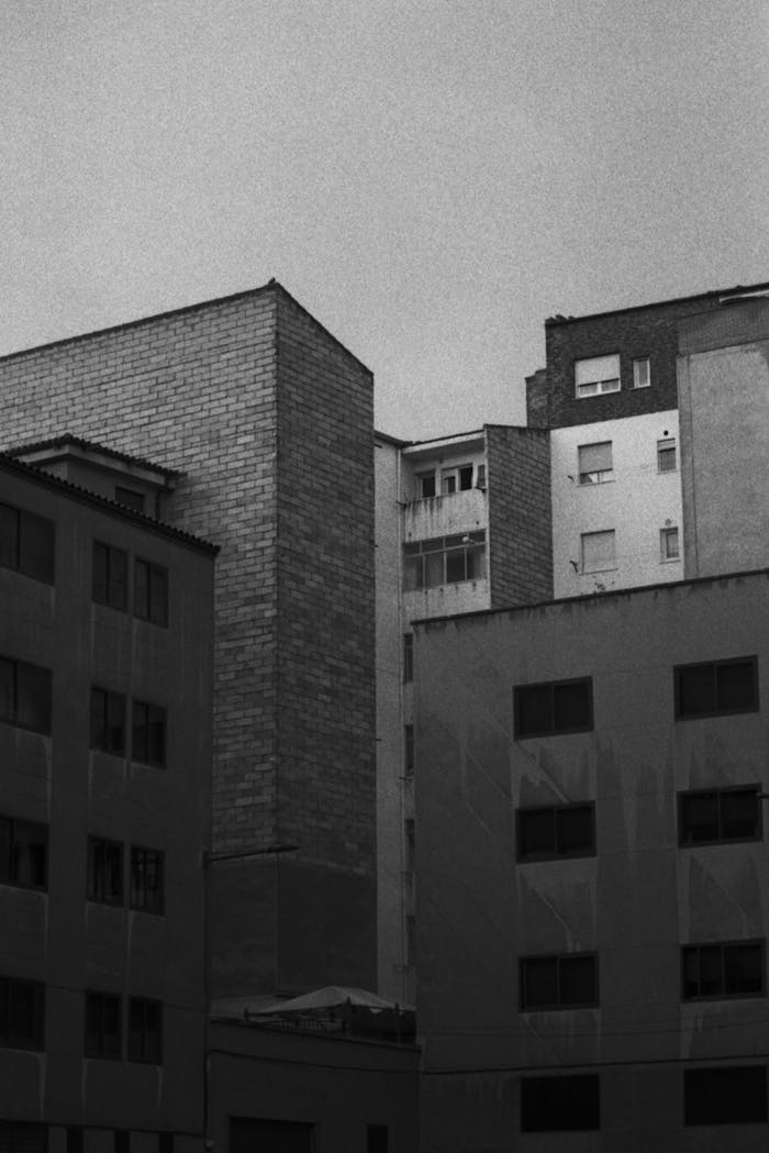 Black and white analog photo capturing Salamanca's urban architecture with high-rise buildings.