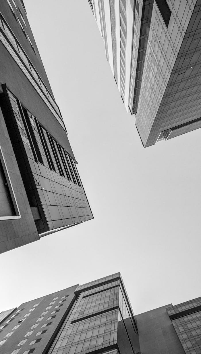 Low angle view of contemporary city buildings under a clear sky.