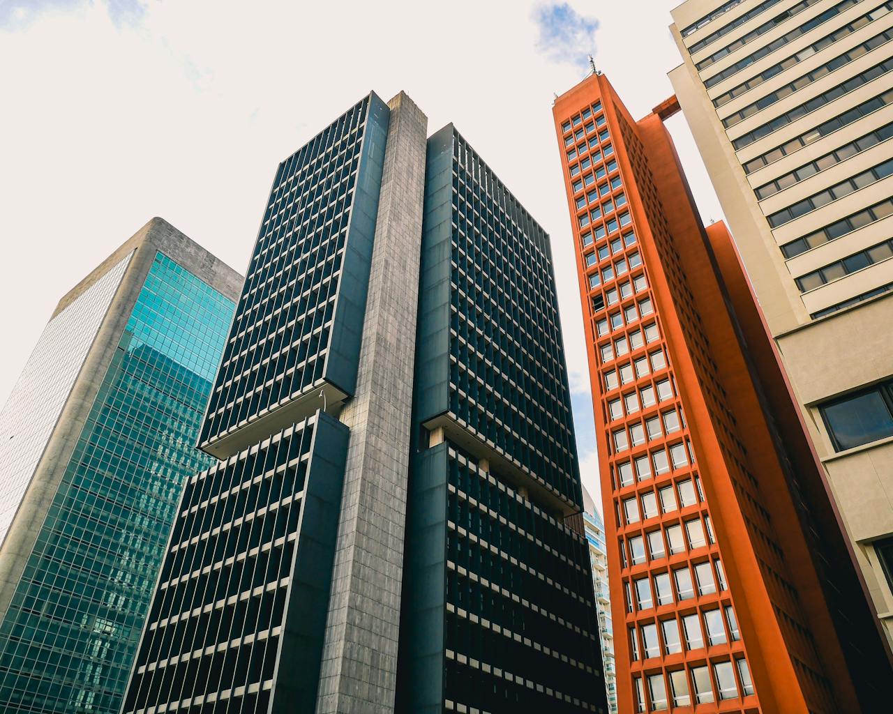 Low angle view of modern skyscrapers against a clear sky.